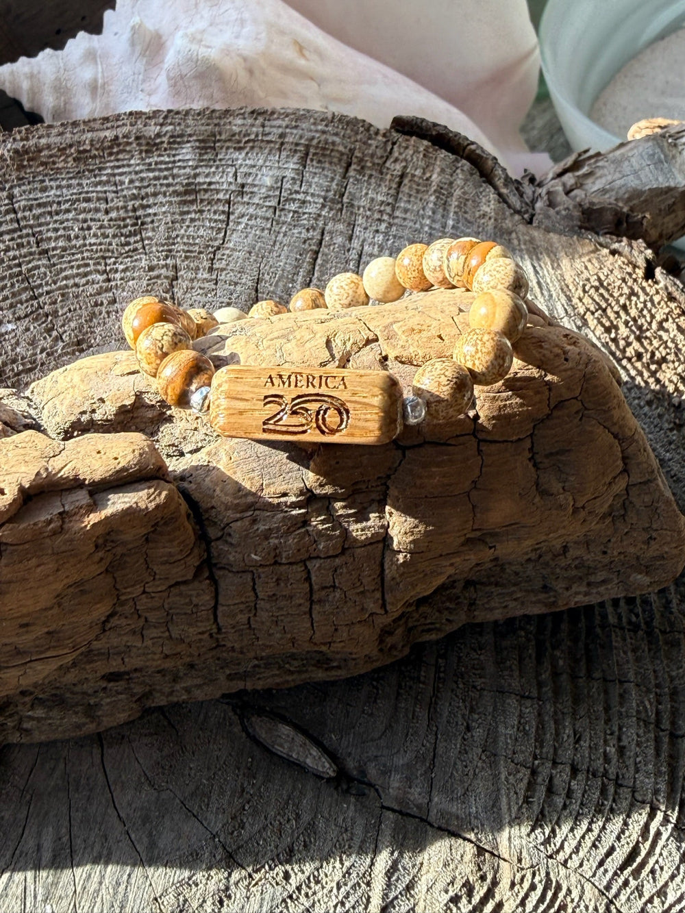 Bracelet with wooden tag on a textured surface