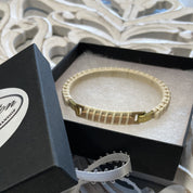 Handcrafted cherry and holly Nauti Clasp Bracelet with brass clasp displayed inside an open black gift box, showing the bracelet as a ready-to-gift presentation.