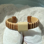 Cherry wood Vista cuff bracelet with a raised holly wood slider bead, a bold wide-profile handcrafted design perfect for solo statement wear — American-made by Military Spouse artisans in Stonington, Connecticut.