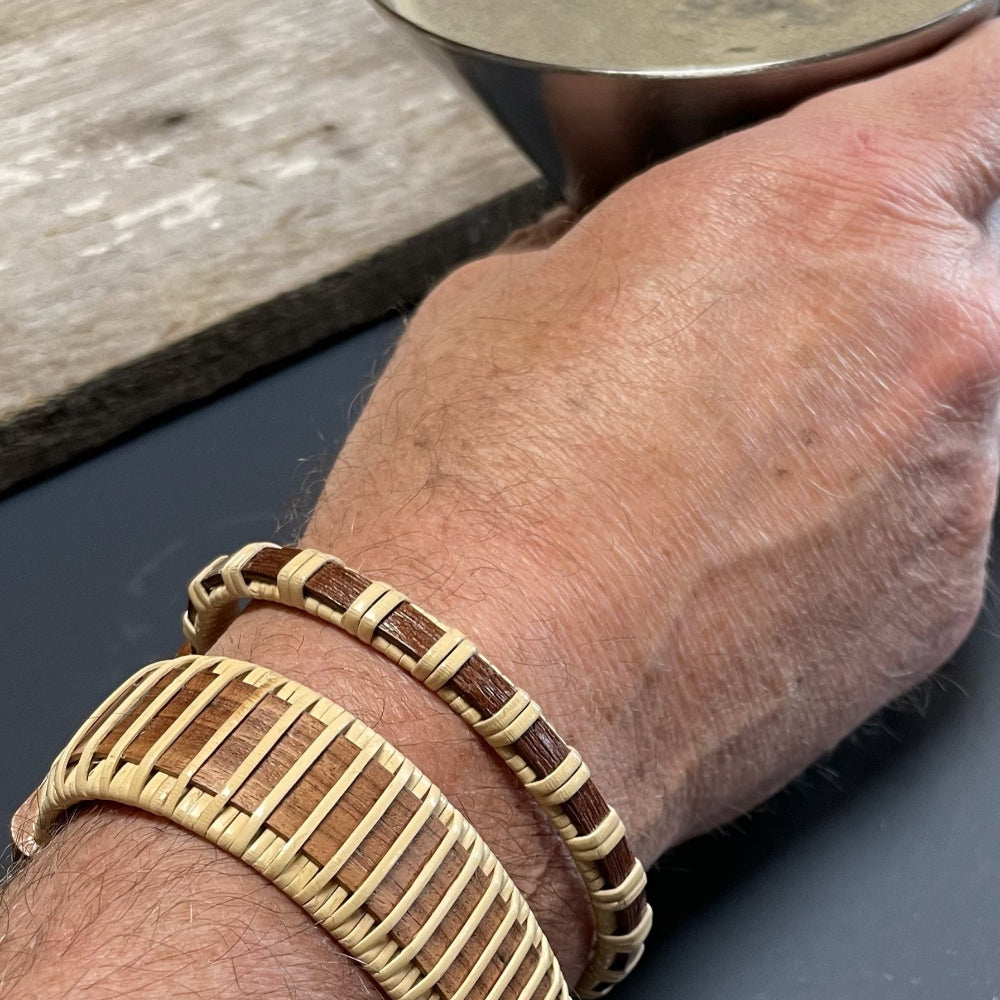 Handcrafted cherry Legacy Cuff Bracelet worn stacked on a man's wrist with a cherry Clubhouse Cuff Bracelet, showing the bold wide silhouette as a statement men's wood bracelet.