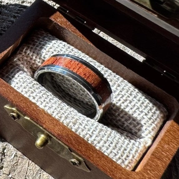 Beacon 8mm tungsten ring with mahogany wood inlay nestled in an open Drift by Stonington Designs engraved wooden gift box.