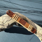 Handcrafted mahogany wood Heritage etched keychain featuring a laser-etched American flag design with light weaver banding, displayed on driftwood — handmade by Military Spouse artisans in Stonington, Connecticut using American-made materials