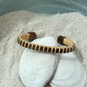 Rosewood Symphony cuff bracelet with a light weaver wrap, a handcrafted statement piece that pairs well with wider cuffs or bead bracelets — American-made by Military Spouse artisans in Stonington, Connecticut.
Image 4 — Navy