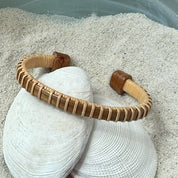 Walnut wood Symphony cuff bracelet with a light weaver wrap, handcrafted with a subtle, light-catching texture — American-made by Military Spouse artisans in Stonington, Connecticut.