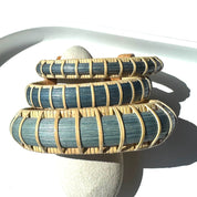 Three Marsh Collection cuff bracelets stacked together in hand-dyed blue bamboo, showing the range of widths from statement to accent.