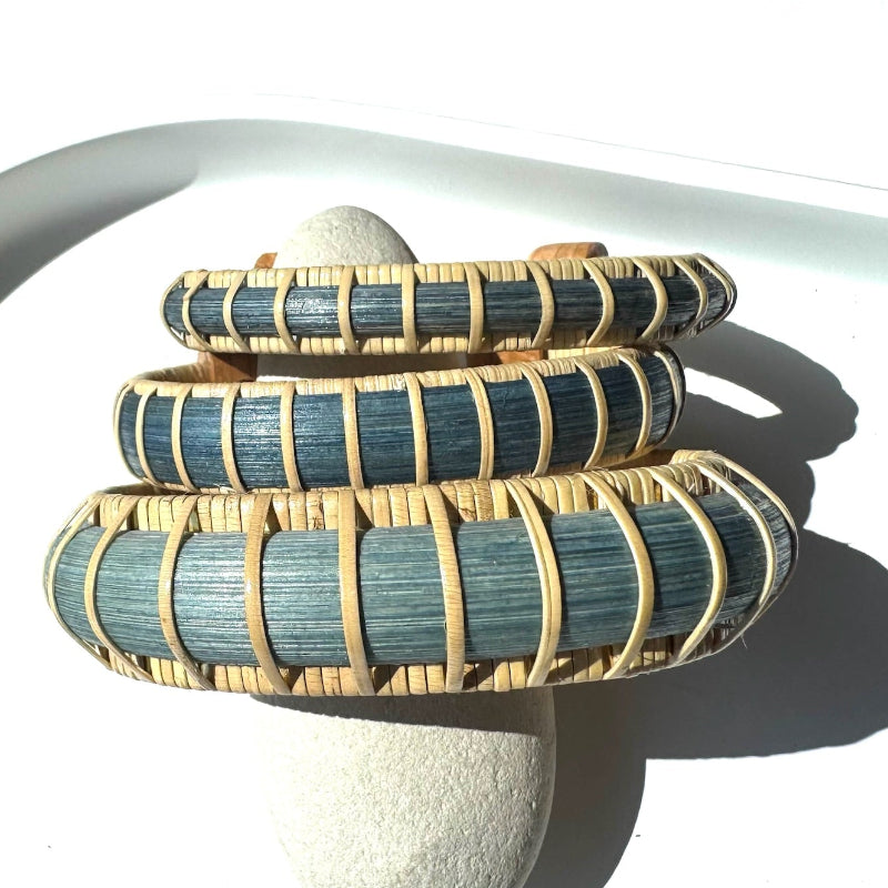 Three Marsh Collection cuff bracelets stacked together in hand-dyed blue bamboo, showing the range of widths from statement to accent.