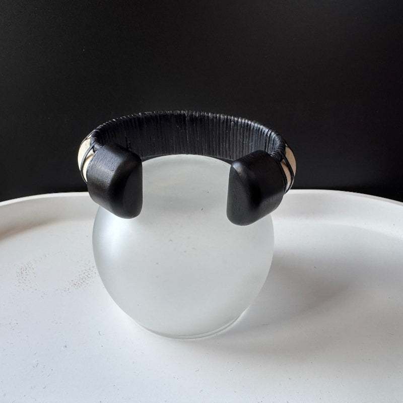 Back view of the Moonbeam cuff showing its two ebony end caps and black woven interior.