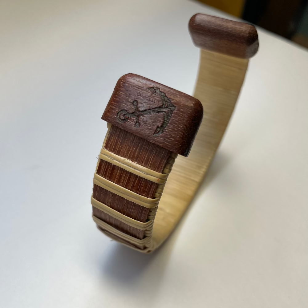 anchor etchd on end caps of a wooden woven bracelet