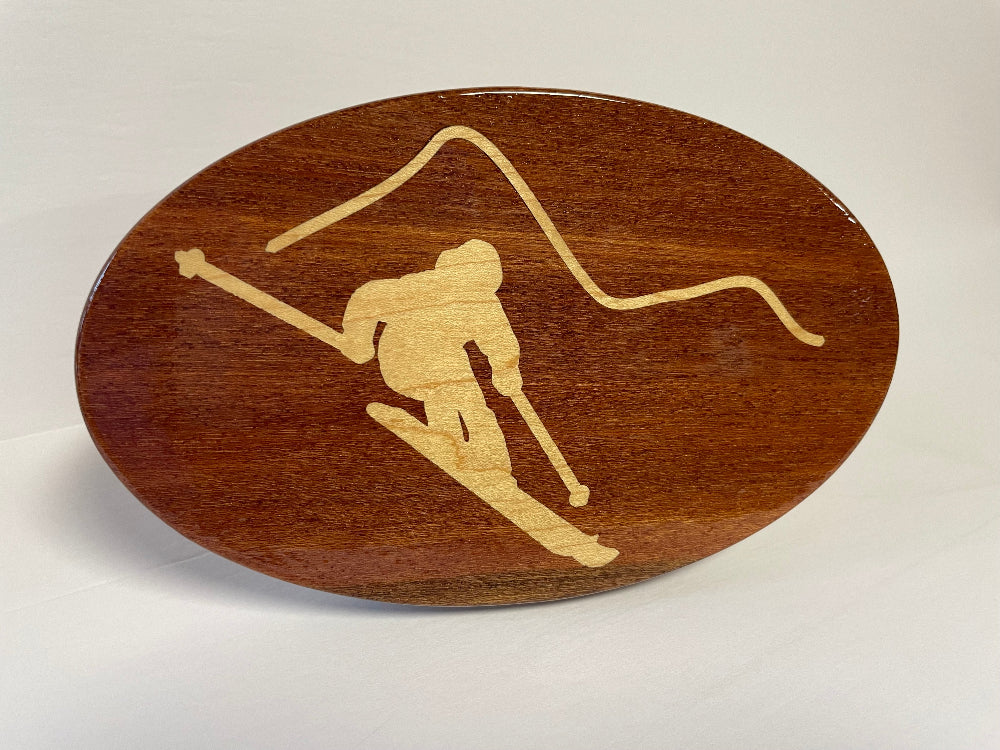 Solid mahogany hitch cover with a maple inlay design of a skier.