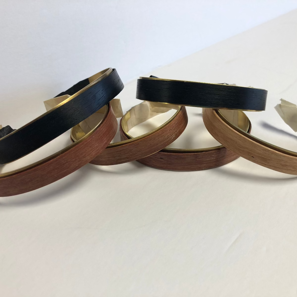 3 tyoes of wood around brass cuffs to show various woods available walnut cherry, purple hear, ebony